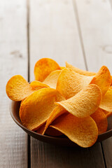 Crispy Potato Chips in Clay Bowl on Rustic Table