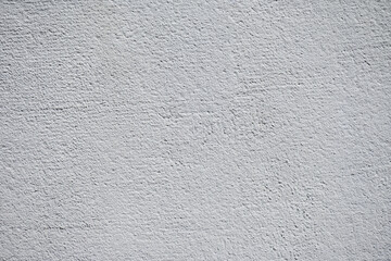 The white wall features a rough texture with slight variations, creating an intriguing backdrop for...