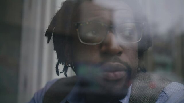Man enjoys coffee while working on laptop at cozy coffee shop