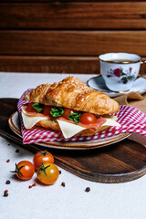 breakfast with coffee and croissant, tomato bacon and cheese