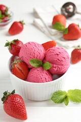 Tasty sorbet with strawberries and mint served on white wooden table, closeup