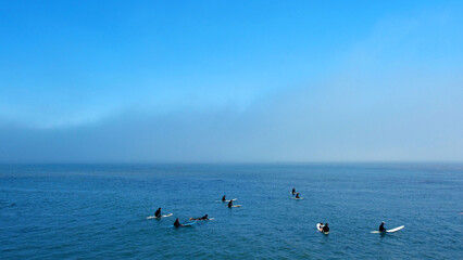 Surfers in a Line Up and Fog on the Horizon
