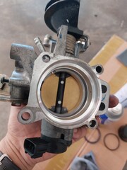 Car engine repair showing throttle body cleaning, sensor inspection, and spark plug maintenance during regular vehicle servicing
