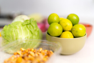 Chef preparing fresh peruvian ceviche with limes, corn, and lettuce