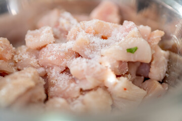 Chef marinating fish with salt for ceviche preparation