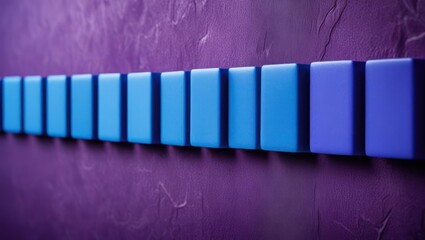 Row of rectangular blocks in shades of blue against a textured purple background.