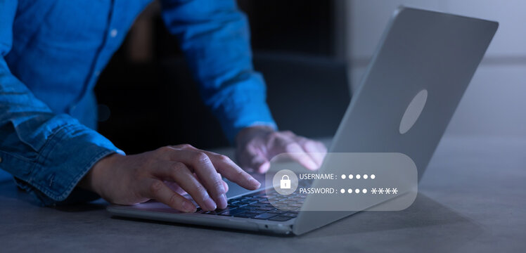 close up developer man hand type keyboard input username and password for register system software on laptop in dark operation office room for cyber security technology concept