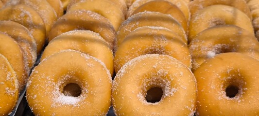Sugar-dusted donuts are a Western-style snack.