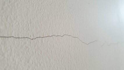 Small cracks on the white wall
