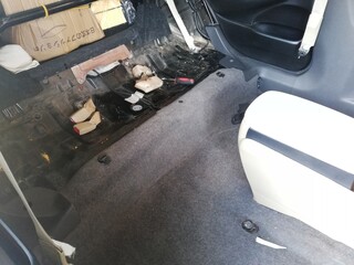 Car soundproofing installation using butyl sheets, foam, and acoustic dampening materials in...