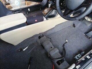 Car soundproofing installation using butyl sheets, foam, and acoustic dampening materials in...