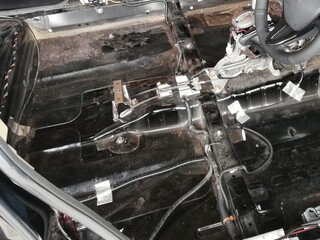Car soundproofing installation using butyl sheets, foam, and acoustic dampening materials in...