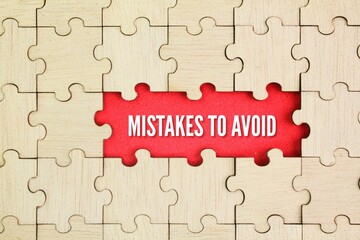 Fototapeta premium Wooden puzzle with the word Mistakes to Avoid. To keep away from or prevent oneself from making mistakes or blunders.