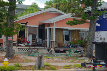 Damaged Home Exterior Showing Structural Deterioration After Natural Disaster. Showcasing a heavily...