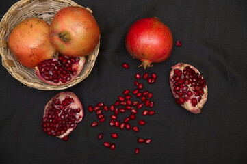 Group of pomegranates, Fresh ripe pomegranate seeds with cut in half, Delicious red ripe juicy pomegranate seed, Artistic Close up Macro, Tropical open Pomegranate with seeds.