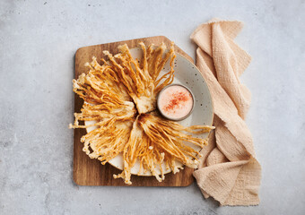 Fried Enoki Mushrooms with sauce on black background, top view