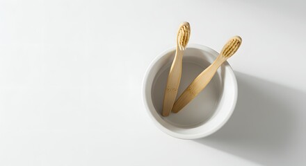 Sustainable Oral Care: Two Eco-Friendly Bamboo Toothbrushes in a White Ceramic Bowl on a Clean Background, Promoting Zero Waste and Environmental C...