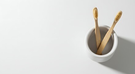 Eco-Friendly Bamboo Toothbrushes in White Ceramic Cup on Clean Background - Sustainable Oral Hygiene and Zero-Waste Lifestyle Concept