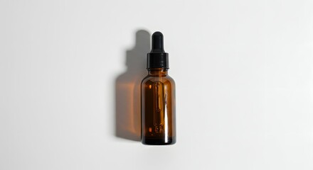 Naklejka premium Minimalist Amber Glass Dropper Bottle with Shadow on White Background, Ideal for Serum or Essential Oil Product Mockup