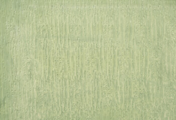 A green wall with a pattern of lines