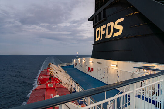 DFDS ferry MS Nordic Crown Seaways highlights its exhaust funnel, lifeboats, and the tranquil evening sea creating a serene atmosphere as it sails forward. Kattegat strait Denmark