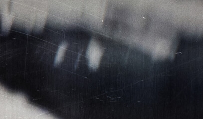 A textured, worn black surface with scratches and scuffs, offering a vintage and artistic appeal...