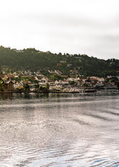 Warm morning sunlight on Drøbak, a charming town in Akershus County, welcomes tourists with its picturesque marina and sunny hillside views, perfect for day trips and sailing adventures