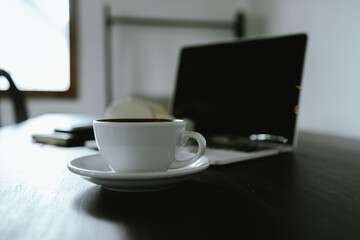 Close-up shot of a creamy latte in a white ceramic mug, evoking the warmth, comfort, relaxation and quiet enjoyment of a quiet and mindful coffee break.
