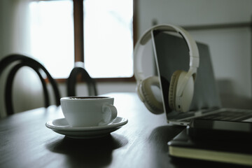 Close-up shot of a creamy latte in a white ceramic mug, evoking the warmth, comfort, relaxation and quiet enjoyment of a quiet and mindful coffee break.