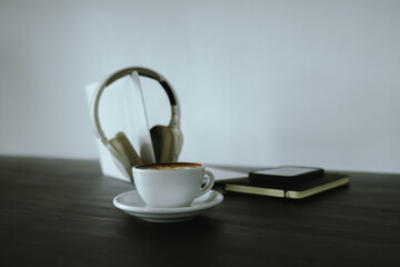 Close-up shot of a creamy latte in a white ceramic mug, evoking the warmth, comfort, relaxation and quiet enjoyment of a quiet and mindful coffee break.