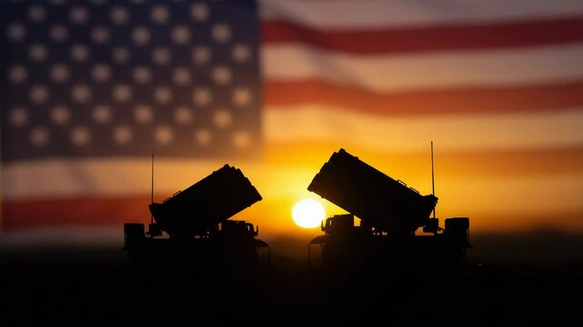 Patriot missile defense systems at sunset with American flag backdrop, symbol of military strength