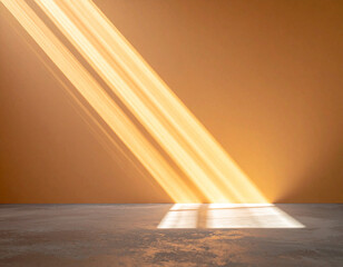Warm sunlight streams through a window casting diagonal stripes of light on a textured wall and floor