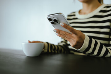 Close-up of woman with creamy latte can satisfy customers' needs in a variety of coffee shops. Meet relaxation, technology and smart food during the daily routine
