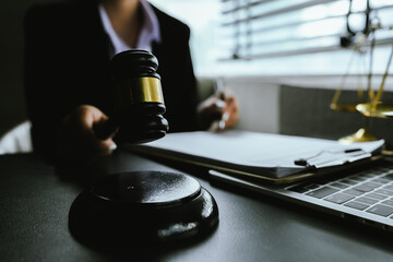 A symbolic image of justice and law, featuring a gavel, scales, and a laptop, representing legal professionalism, court systems, ethics, remote legal work, and modern legal services.