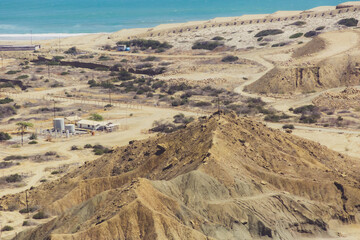 A desert landscape with a small town in the distance