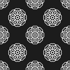 abstract seamless pattern of hand drawn mandala on black background 