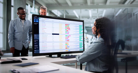 Diverse Team Of Professionals Using Spreadsheets