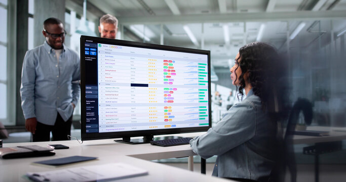 Diverse Team Of Professionals Using Spreadsheets