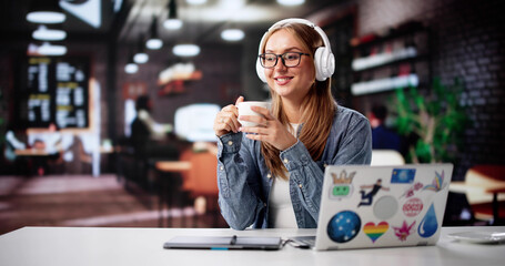 Smiling Young Woman Designer Utilizing Laptop In Trendy Coffee Shop