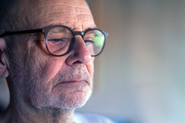 Close-Up Portrait of a Thoughtful Senior Man Wearing Glasses