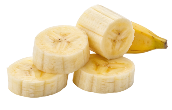 A close up view of a pile of banana slices with a partial banana on a black background clearly visible