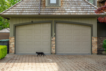 Garage door in luxury house with trees and nice landscape in Spring in Vancouver, Canada, North...