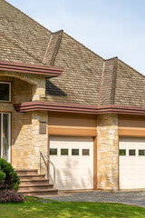 Garage door in luxury house with trees and nice landscape in Spring in Vancouver, Canada, North...