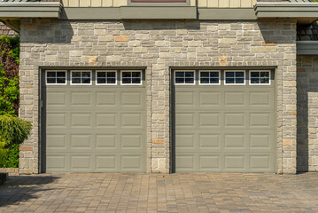 Garage door in luxury house with trees and nice landscape in Spring in Vancouver, Canada, North...