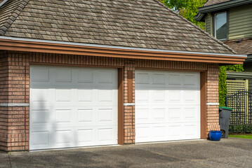 Garage door in luxury house with trees and nice landscape in Spring in Vancouver, Canada, North...