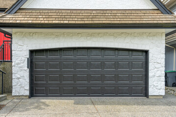 Garage door in luxury house with trees and nice landscape in Spring in Vancouver, Canada, North...