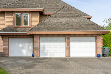 Garage door in luxury house with trees and nice landscape in Spring in Vancouver, Canada, North...