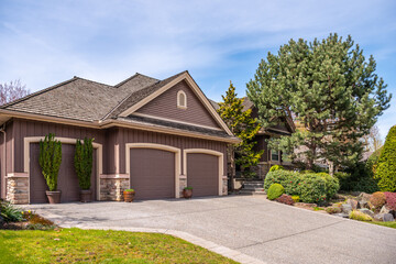 Garage door in luxury house with trees and nice landscape in Spring in Vancouver, Canada, North...