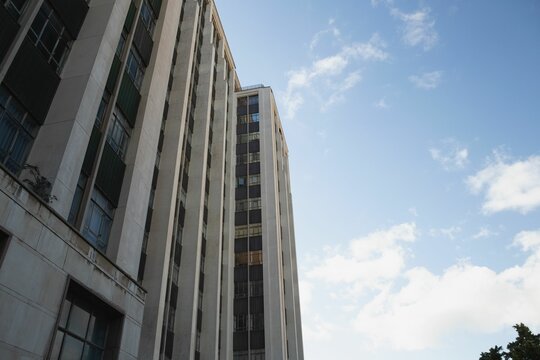 Fototapeta view of office building against blue sky
