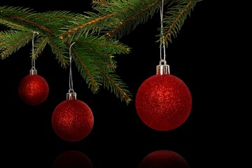 Three red glitter baubles are hanging from lush pine branch in 3D render with dark backdrop © vectorfusionart